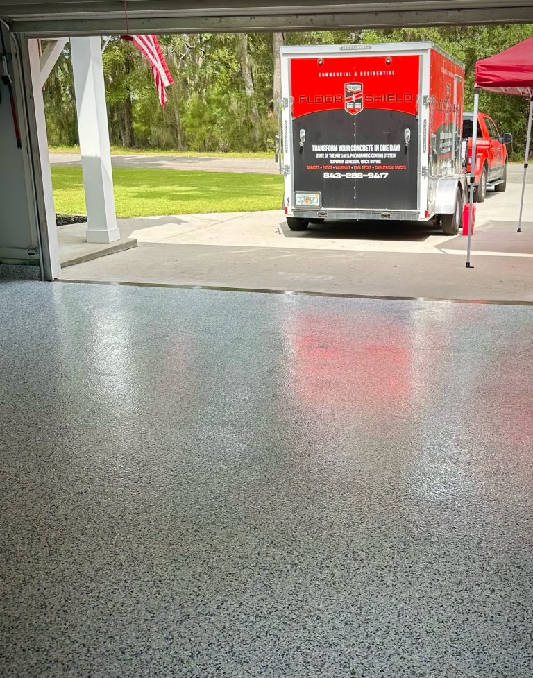 Glossy garage floor with the Floor Shield trailer outside