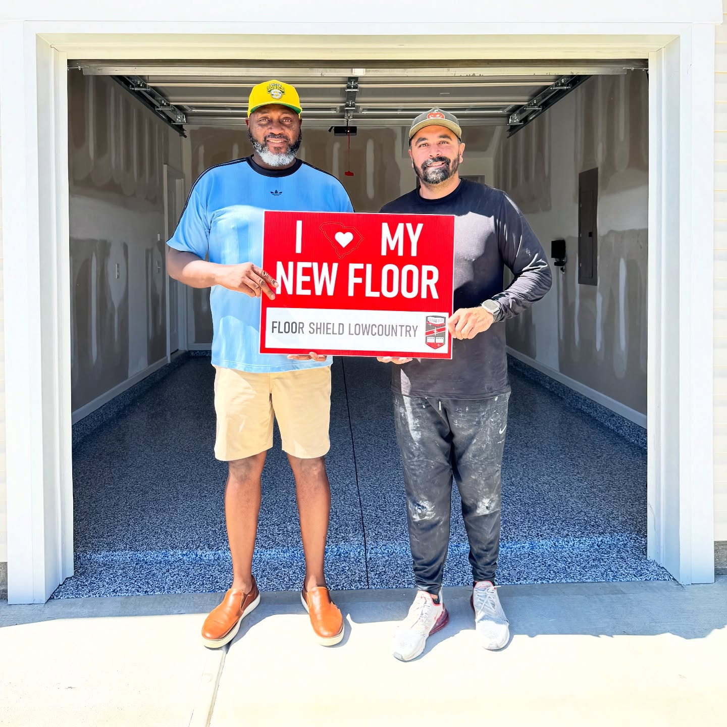 Happy homeowners with an I love my new floor sign