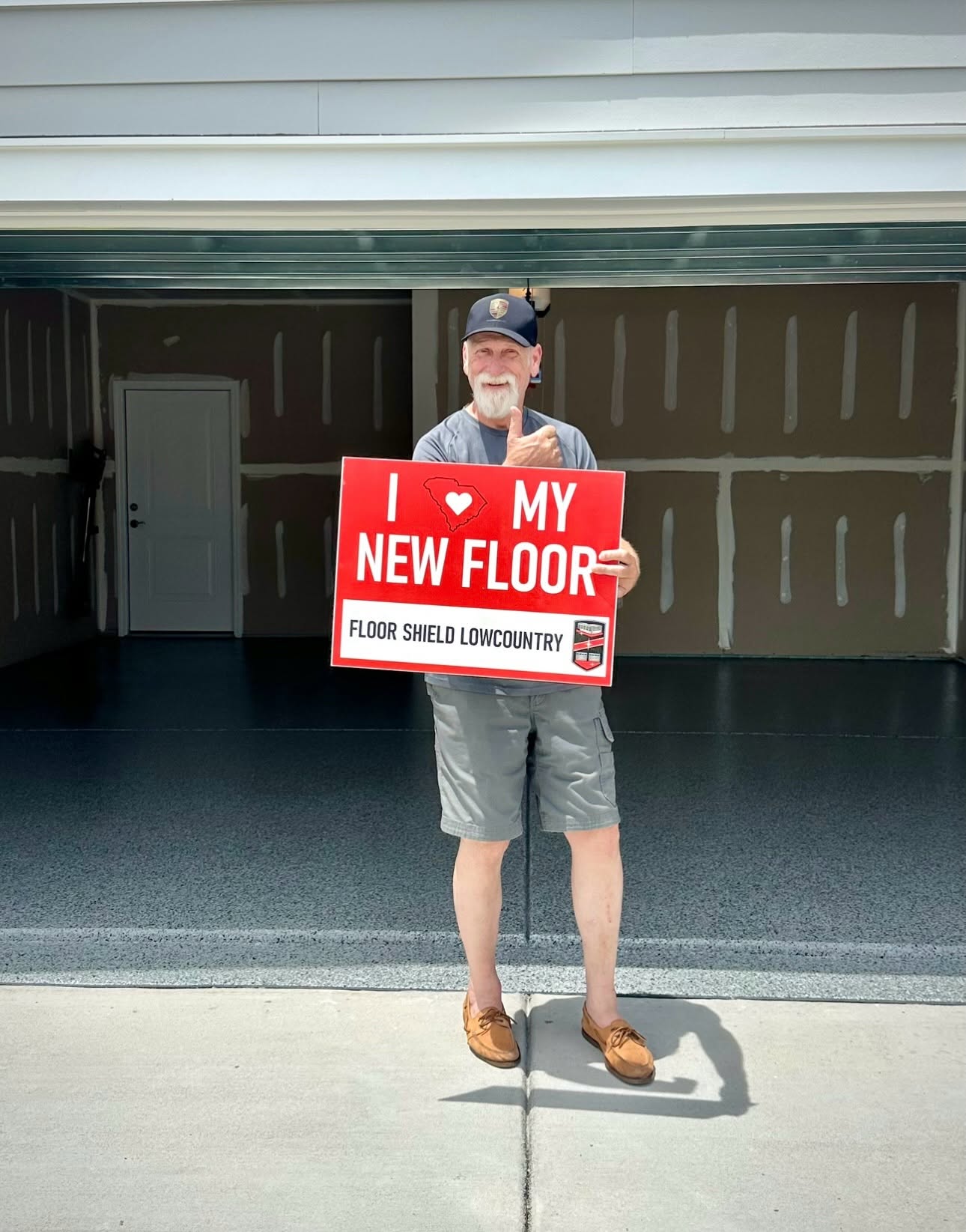 Homeowner with an I love my new floor sign