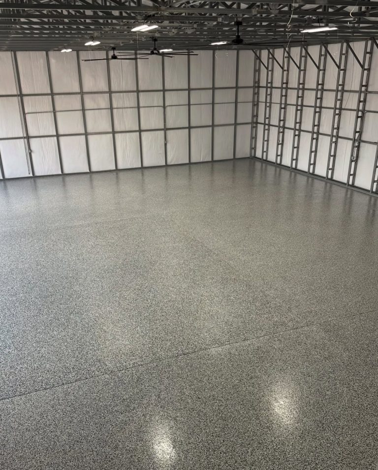 Empty two-car garage with a light flake floor coating
