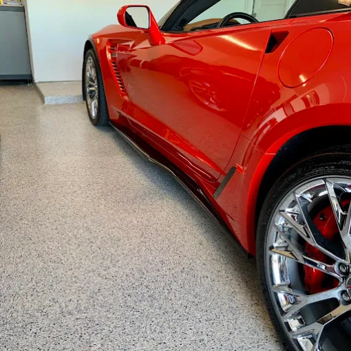 Red sports car on a gray flake garage floor