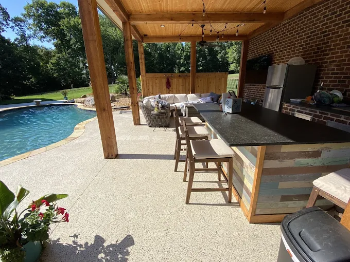 Covered patio with an outdoor kitchen and flake floor